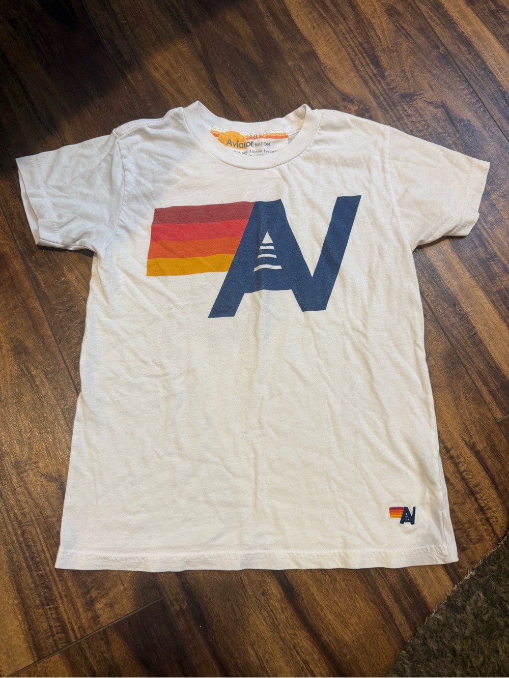 Aviator Nation Kids White Tee with Navy AV Logo and Red-Orange-Yellow Stripes